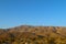 Blue sky rolling desert mountains horizon