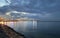 Blue sky and sea water evening harbor promenade cruise ship blurred city light dramatic clouds nature background Tallinn baltic Se