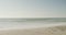 Blue sky and sea with waves on empty and sunny beach