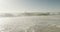 Blue sky and sea with waves on empty and sunny beach