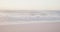 Blue sky and sea with waves on empty sunny beach