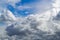 The blue sky shines through the clouds. Beautiful white cumulus clouds in the blue sky.