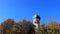 Blue Sky With Small Topical Church And Golden Cross