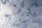 Blue sky with soft puffy clouds, close-up background