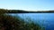 Blue sky with sunshine over beautiful serene remote northern Minnesota lake