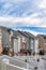 Blue sky and thick clouds over scenic neighborhood landscape with townhouses