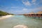 Blue sky turquoise water luxury Overwater Villa connected to Beach with Platform at a resort island, Maldives