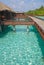 Blue sky turquoise water a perfect Holiday on Overwater Bungalow wooden platform walkway at a tropical resort island, Maldives