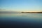 Blue sky water lake, mountains silhouette at horizon line and clear sky