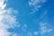 Blue sky with white altocumulus and cirrus clouds