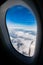 Blue sky white cloud ,looking through airplane window frame
