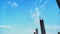 Blue sky with white clouds and building pillars in the morning.