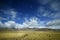 The blue sky white clouds and grassland snow mountain landscape