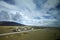 The blue sky white clouds and grassland snow mountain landscape