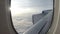 Blue sky and white clouds  from inside airplane cabin window