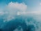 Blue sky with white clouds over calm summer panorama of the sea. Drone aerial view. Abstract aerial nature summer ocean