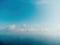 Blue sky with white clouds over calm summer panorama of the sea. Drone aerial view. Abstract aerial nature summer ocean