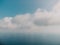 Blue sky with white clouds over calm summer panorama of the sea. Drone aerial view. Abstract aerial nature summer ocean