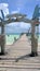 Blue sky and white clouds over a tropical pier that stretched out in to the crystal blue sea. Cayo Guilermo , Cuba