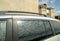 Blue sky with white clouds, reflecting in window of car