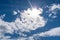 Blue sky and white clouds with a sunburst cloudscape