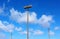 Blue sky, white clouds and three road lamps