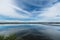 Blue sky and white clouds, water reflections in salt farming Na