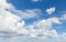 Blue sky with white cumulus and altocumulus types of clouds