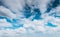 Blue sky white fluffy clouds background. Beautiful blue sky and white cumulus clouds abstract background. Cloudscape background.