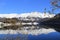 Blue sky, white mountain, lake and the withered tree