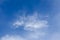 Blue sky and white wispy cloud background