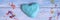 Blue slime clod in heart form on blue wooden background. banner.