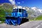 Blue snowplow in a parking on the Grossglockner High Alpine Road in summer time..