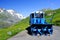 Blue snowplow in a parking on the Grossglockner High Alpine Road in summer time..
