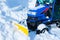 Blue snowplow removes snow, winter, road after snowfall, vertical