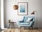 Blue snuggle chair against white wall with art poster frame and pendant light. Mid century style interior design of modern room