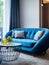 Blue sofa and armchairs near round coffee table. Interior design of modern living room