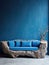 Blue sofa made of tree trunk root over blue empty wall with copy space. Rustic interior design of modern living room