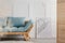 Blue sofa with pillows in elegant living room interior. Real photo with copy space on