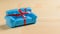 Blue sofa with red ribbon wooden floor made of light wood. Unusual gift