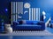 Blue sofa in room with abstract geometric shapes furniture pieces. Postmodern Memphis style interior design of modern room