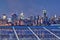 Blue solar cell panels, New York skyline illuminated at night
