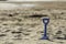 A blue spade in the sand on a Cornwall beach