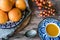 Blue Spanish handmade plate with oranges, juice and silver spoon on wooden table