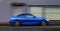 Blue speedy car moving on the road motion blurred image