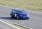 Blue sportcar in a race