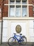 Blue sports bicycle under the street wall blazon of Manufacture trade association