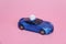 The blue sports car carries a crystal flower. The gift lies on the roof of the car