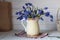 blue spring flowers in a jug. cottage core.