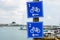 Blue square shaped bicycle lane route signs with route numbers on metal pole